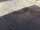 Una delle buche asfaltate al cimitero delle Grazie